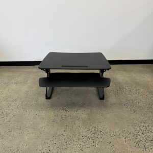 Image is of a dark item on a floor.