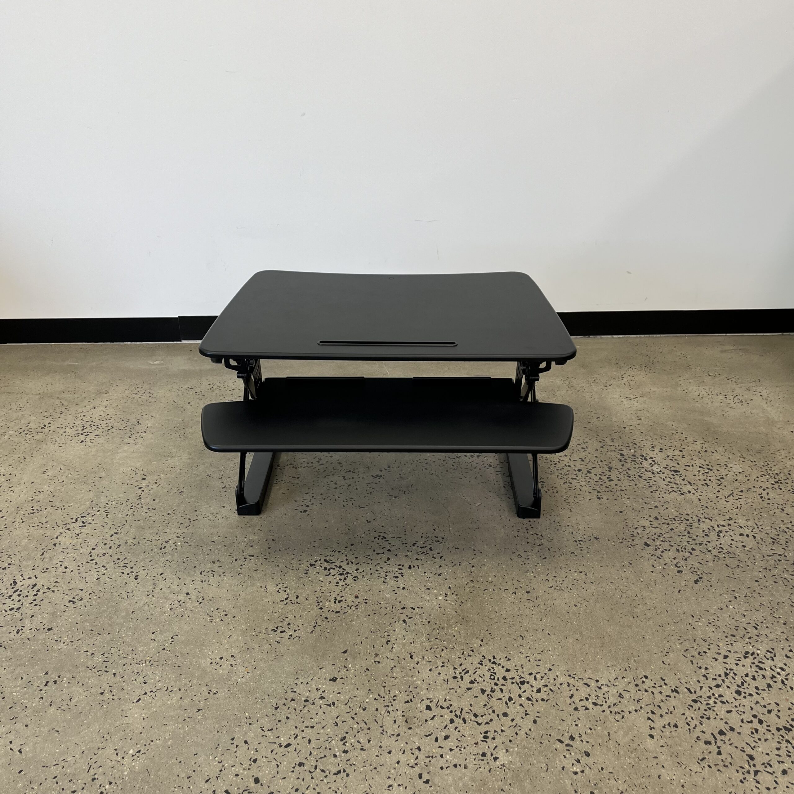 Image is of a dark item on a floor.